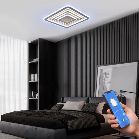 Dormitorio moderno decorado con Plafón Smart Otie 2 encendido y controlado con un móvil con iluminación combinada en tono frío