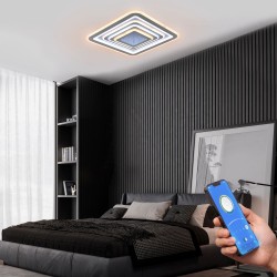 Dormitorio moderno decorado con Plafón Smart Otie 2 encendido y controlado con un móvil con iluminación combinada en tono cálido