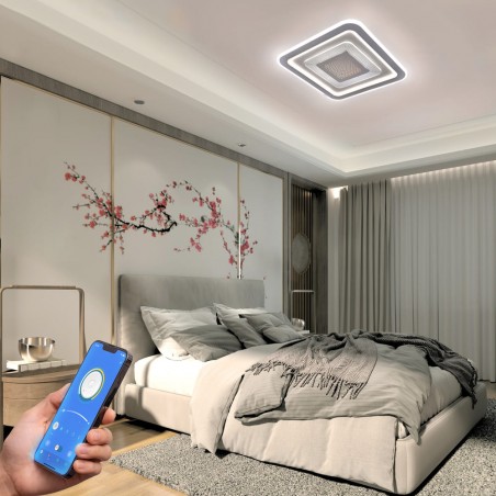 Dormitorio decorado con el Plafón Smart Otie encendido y controlado desde un móvil con iluminación combinada en tono neutro