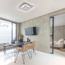 Oficina moderna decorada con el Plafón Smart Ara 70W 3CCT regulable encendido con iluminación combinada en tono de luz neutra
